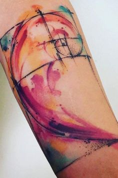 a colorful tattoo with an abstract design on the arm