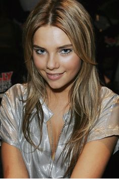 a beautiful young woman sitting at a table