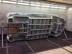 a large metal object sitting on top of a floor in a room with grates