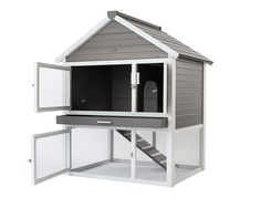 a gray and white bird house with stairs to the second floor on an isolated white background