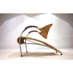 a chair made out of metal and wicker with an arrow on the backrest