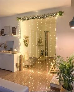 a living room filled with furniture and christmas lights on the wall above it's doorway