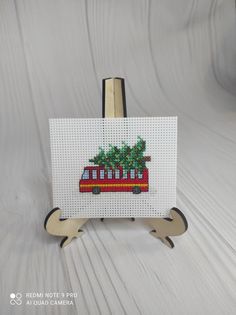 a red bus with a christmas tree on the top is shown in front of a white background