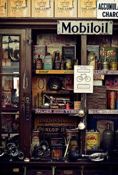 an old fashioned store front with many different items on the shelves and below it is a sign that says mobiloli