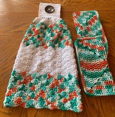 a crocheted dish cloth and pot holder on a wooden table