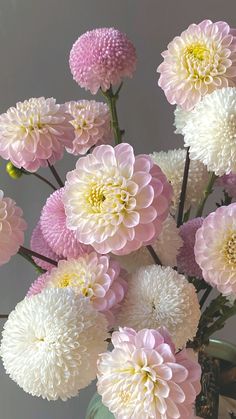 a vase filled with lots of pink and white flowers