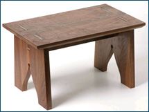 a small wooden table sitting on top of a white floor