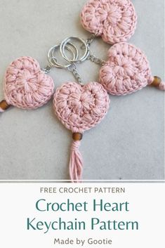 the crochet heart keychain pattern is made by goetie and has three hearts attached to it