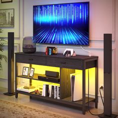 a flat screen tv sitting on top of a wooden entertainment center next to a book shelf