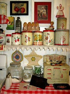 an old fashioned kitchen with many items on the shelves and below it is a video player