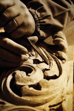 a person working on some kind of object with their hands over it's work