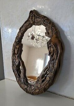 an ornate wooden mirror on the wall