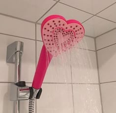 a shower head with two hearts on it