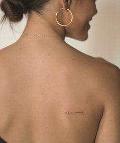 a woman with a small tattoo on her back