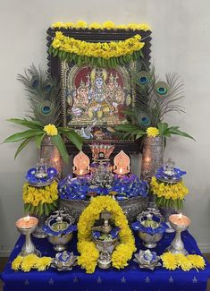 the altar is decorated with yellow flowers and peacocks