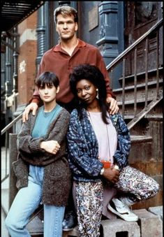 three people are posing for a photo on the steps