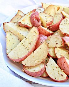 a white plate topped with sliced potatoes on top of a table