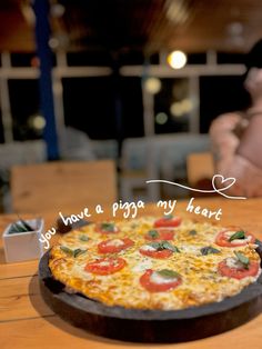 a pizza sitting on top of a wooden table