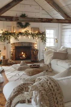 a living room filled with furniture and a fire place covered in christmas garlands next to a fireplace