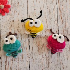 three small crocheted stuffed animals sitting on top of a wooden table next to each other