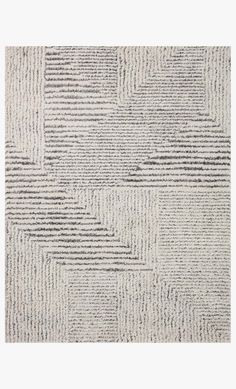 a white rug with black and grey stripes on the bottom, in an abstract pattern