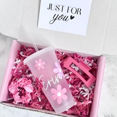 a pink gift box filled with confetti and a sippy cup that says just for you