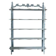 an old wooden shelf with three shelves on it's sides and one is painted blue