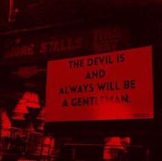 a red sign that says the devil is and always will be a gentleman