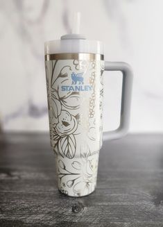 a starbucks cup sitting on top of a wooden table