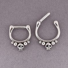 pair of skull hoop earrings on grey background