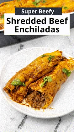 shredded beef enchiladas on a white plate