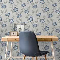 a blue chair sitting in front of a wooden desk