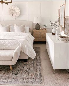 an instagram photo of a bedroom with white bedding and decor on the walls