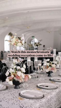 the table is set with white and pink flowers