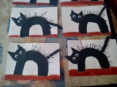 four pieces of paper cut out to look like black cats with spikes on their heads