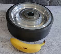 a banana sitting next to a metal wheel