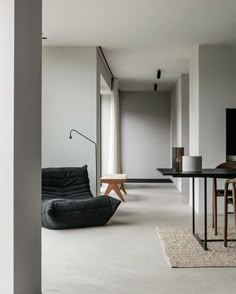 a living room filled with furniture and a flat screen tv on top of a wooden table