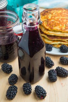 blackberry syrup and pancakes on a wooden table