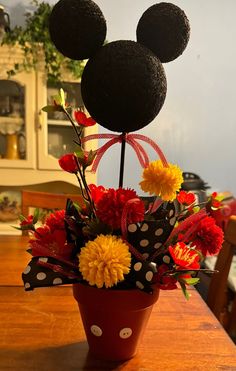 a mickey mouse flower arrangement in a pot