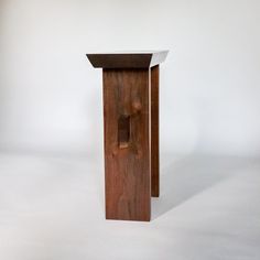 a small wooden table sitting on top of a white floor