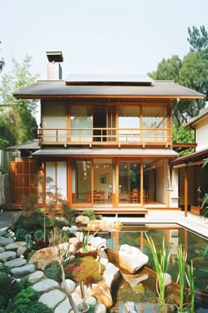 Classic Japanese house exterior with traditional architecture and a garden pond. Japanese House With Garden, Japan Home Exterior, Japanese Inspired House Exterior, Japanese Style Home Exterior, Wooden House Designs Exterior, Japanese Cottage House, Japanese Style Houses, Big Japanese House, Beautiful Homes Exterior Modern