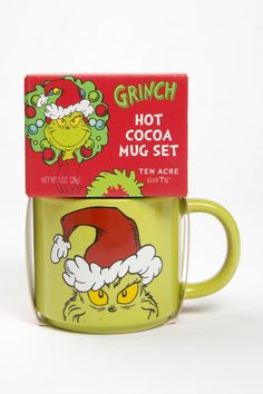 a green coffee mug with grinch on it