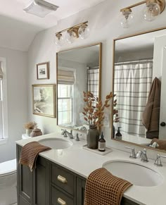 a bathroom with two sinks and mirrors in it