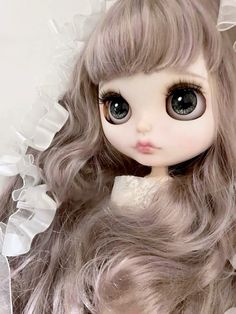 a close up of a doll with long hair