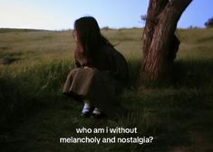 a woman sitting under a tree with the words who am i without melancholy and nostalia?