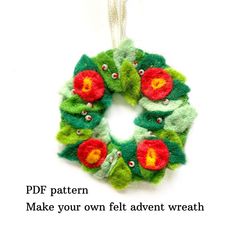 a felt wreath ornament hanging on a white background with the words pdf pattern make your own felt adventent wreath