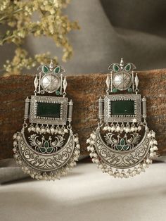 These beautiful statement emerald green dangler earrings will compliment any outfit! Made in high quality German silver, these are light weight and easy to wear.  For any queries, please feel free to contact us. Happy shopping! Luxury Green Danglers For Reception, Cheap Silver Earrings For Festival, Cheap Heavy Earrings As Gift, Cheap Green Earrings For Festive Season, Cheap Silver Danglers For Festive Occasions, Luxury Silver Danglers For Festive Occasions, Luxury Silver Kundan Bridal Earrings, Cheap Heavy Earrings For Festivals, Cheap Heavy Earrings For Gift