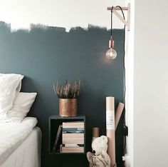 a bedroom with green walls and white bedding