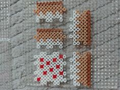 two cross stitch letters made out of plastic beads