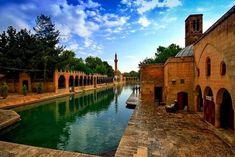 the water is green and clear in this old city area with brick buildings on both sides